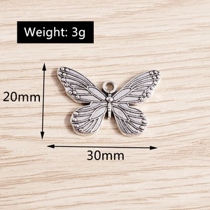 Macro detail of vintage silver butterfly pendant with size and weight measurements