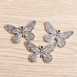Vintage silver butterfly alloy pendants with intricate relief texture for DIY jewelry making