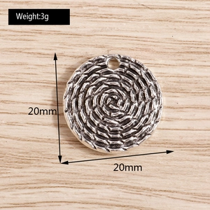 Detailed macro view of 20mm vintage silver alloy woven texture round pendant connector