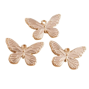 Set of three golden vintage butterfly charms with detailed texture for DIY jewelry