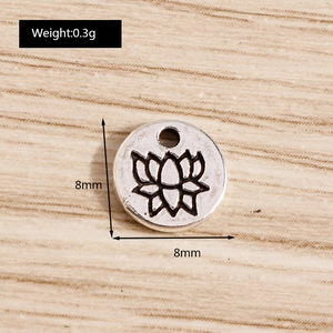 Macro detail of antique silver lotus flower pendant with 8mm dimensions and engraved texture