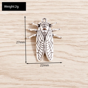 Detail view of vintage silver cicada charm showing 27mm x 22mm size dimensions