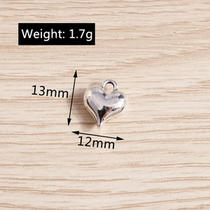 Silver heart pendant for DIY jewelry making with dimensions 13mm by 12mm and hanging loop