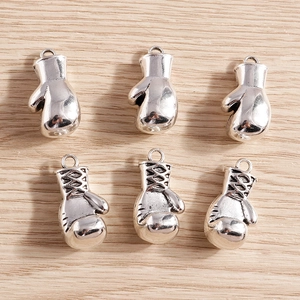 Detailed macro view showing smooth and textured silver alloy boxing glove pendants