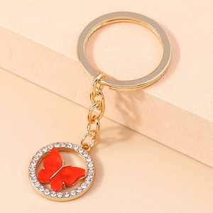 Detail of red butterfly keychain with sparkling crystals and gold alloy chain finish