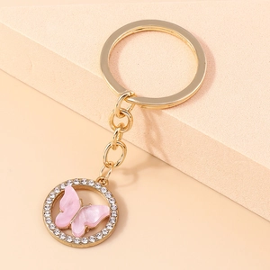 Detail of pink acrylic butterfly keychain with sparkling crystal rhinestones and gold ring