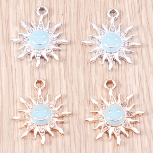 Detail of sunflower charms with light blue enamel smiley face and sparkling rhinestones