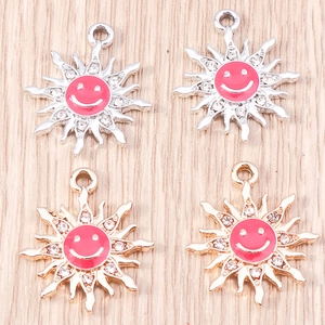 Detail view of sunflower smile charms with pink enamel and sparkling crystals