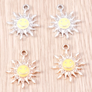 Detail of alloy sun sunflower pendants with yellow enamel smileys and white rhinestones