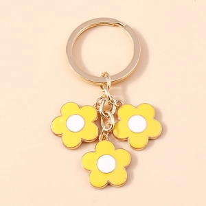 Elegant gold keychain featuring three yellow enamel cherry blossom flower pendants