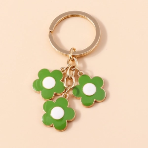 Floral keychain with three green and white enamel flower charms on a golden ring hook