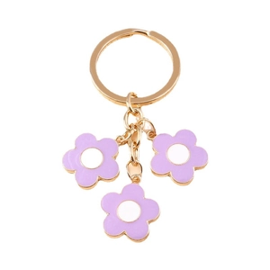 Golden keychain with three purple cherry blossom pendants on a clean white background