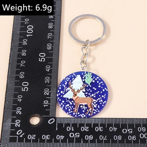 Detail view of round acrylic Christmas elk keychain with size scale and 6.9g weight info