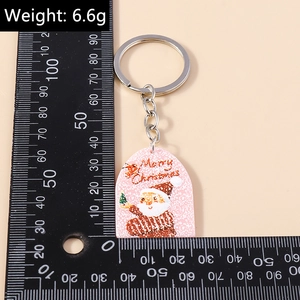 Detailed view of a Santa Claus acrylic keychain with Weight 6.6g and size measurement
