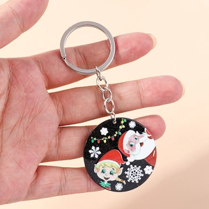 Handheld Christmas keychain with round cartoon Santa Claus and elf prints on a light background