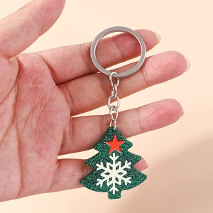 Sparkly green Christmas tree keychain with white snowflake and red star on silver ring