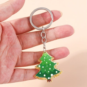 Green acrylic Christmas tree keychain with golden glitter edges and silver metal ring charm