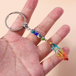Detailed view of evil eye beads and rainbow crystal column keychain on a metal ring
