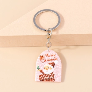 Detail of pink acrylic Santa Claus keychain with Merry Christmas text and silver metal ring