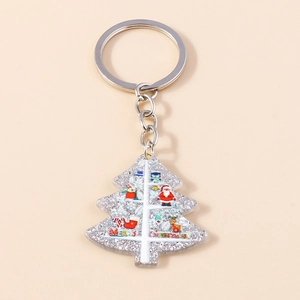 Detail of Christmas tree keychain with silver glitter acrylic and festive Santa patterns