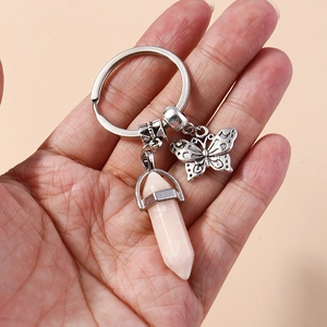 Detail of hand-held retro silver butterfly pendant with pink hexagonal crystal stone