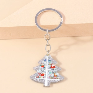 Detailed macro view of the acrylic Christmas tree keychain with silver metal ring buckle