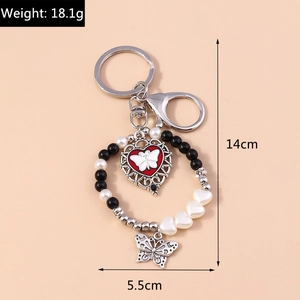 Detail of butterfly heart pendant with dimensions 14cm by 5.5cm and 18.1g weight