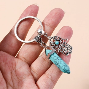 Hamsa Hand and turquoise hexagonal prism crystal keychain in silver metal finish