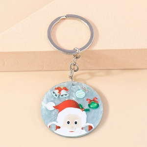 Close-up of Santa Claus and bells pattern on light blue marble texture keychain pendant