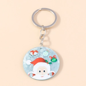 Detail shot of acrylic Christmas keychain featuring Santa Claus and bell patterns