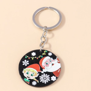 Close-up of a round acrylic Santa Claus keychain with festive reindeer and snowflake prints
