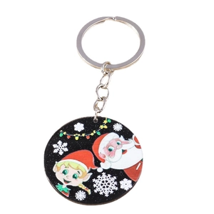 Christmas round keychain featuring Santa and elf on black background with silver ring