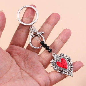 Gothic butterfly heart keychain with silver openwork metal and dark red heart pendant