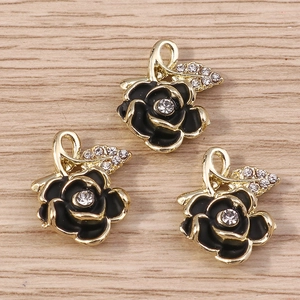 Set of luxury gold rose pendants with black enamel and sparkling diamond rhinestones