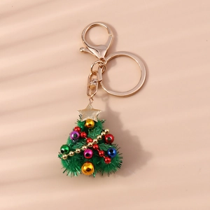 Detailed close-up of a plush green Christmas tree keychain with colorful beads and golden star