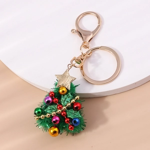 Detail of Christmas tree keychain with green sequins, colorful beads and a gold star