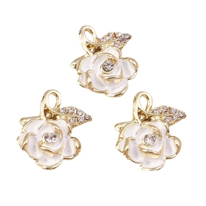 Three elegant gold rose flower charms with white enamel and sparkling diamond accents