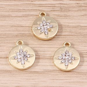 Macro detail of three gold octagonal star coin pendants with sparkling white rhinestones