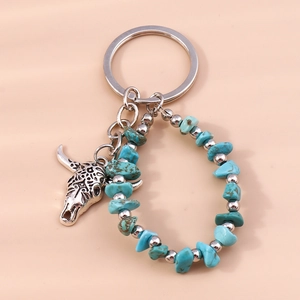 Macro shot of turquoise stone beads and vintage carved bull head pendant keychain