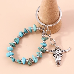 Bohemian key chain with turquoise beads and vintage silver bull head pendant on wood stand