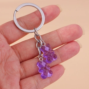 Detailed close-up of a purple gummy bear keychain with a durable silver metal ring