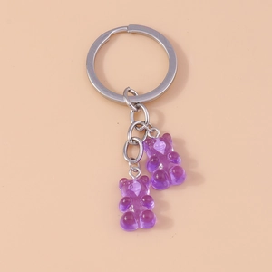 Close-up of translucent purple gummy bear charms on a metallic silver keyring
