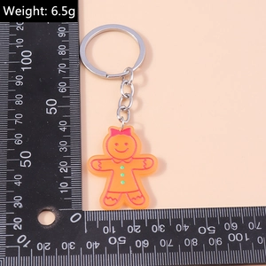 Porte-clés bonhomme en pain d'épices avec anneau et règle montrant le poids