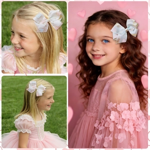 Detail of pink and blue ribbon hair clips with gold glitter hearts for girls