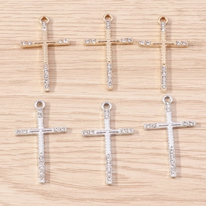 Detailed view of alloy cross pendants with crystals in gold and silver plating
