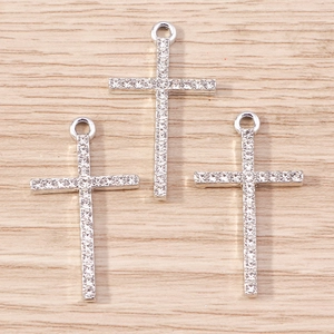 Macro shot of silver plated cross pendants with inlaid rhinestones and top loops
