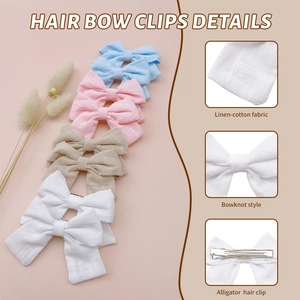 Detail of linen-cotton fabric bow clips featuring alligator clips in four soft colors