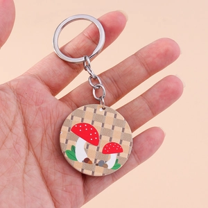 Détail d'un porte-clés rond avec motif de champignons et texture à carreaux rétro
