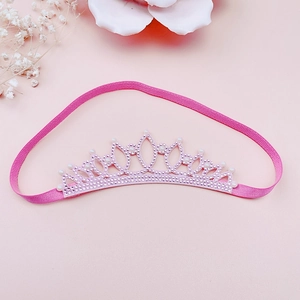 Detail of pink rhinestone crown headband with soft elastic strap and white pearls