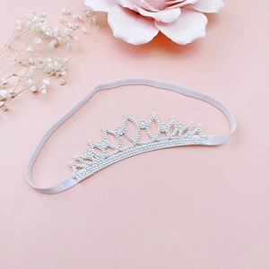 Close-up of sparkling rhinestone princess crown headband with elegant white pearls